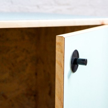 Credenza in mint green and vanilla laminate, pine wood, and OSB with recycled black door knobs by Atelier Antipode