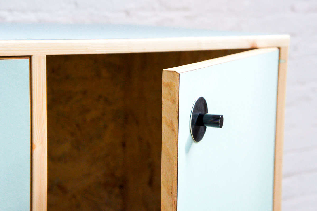 Credenza in mint green and vanilla laminate, pine wood, and OSB with recycled black door knobs by Atelier Antipode