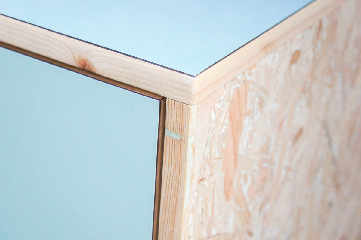 Credenza in mint green and vanilla laminate, pine wood, and OSB with recycled black door knobs by Atelier Antipode