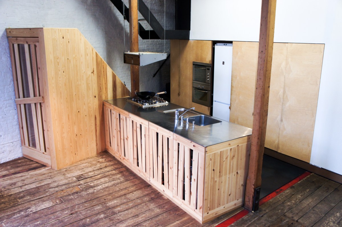 Atelier Antipode See-through kitchen doors in pine wood. The wooden laths are set up in an alternating zig zag pattern.