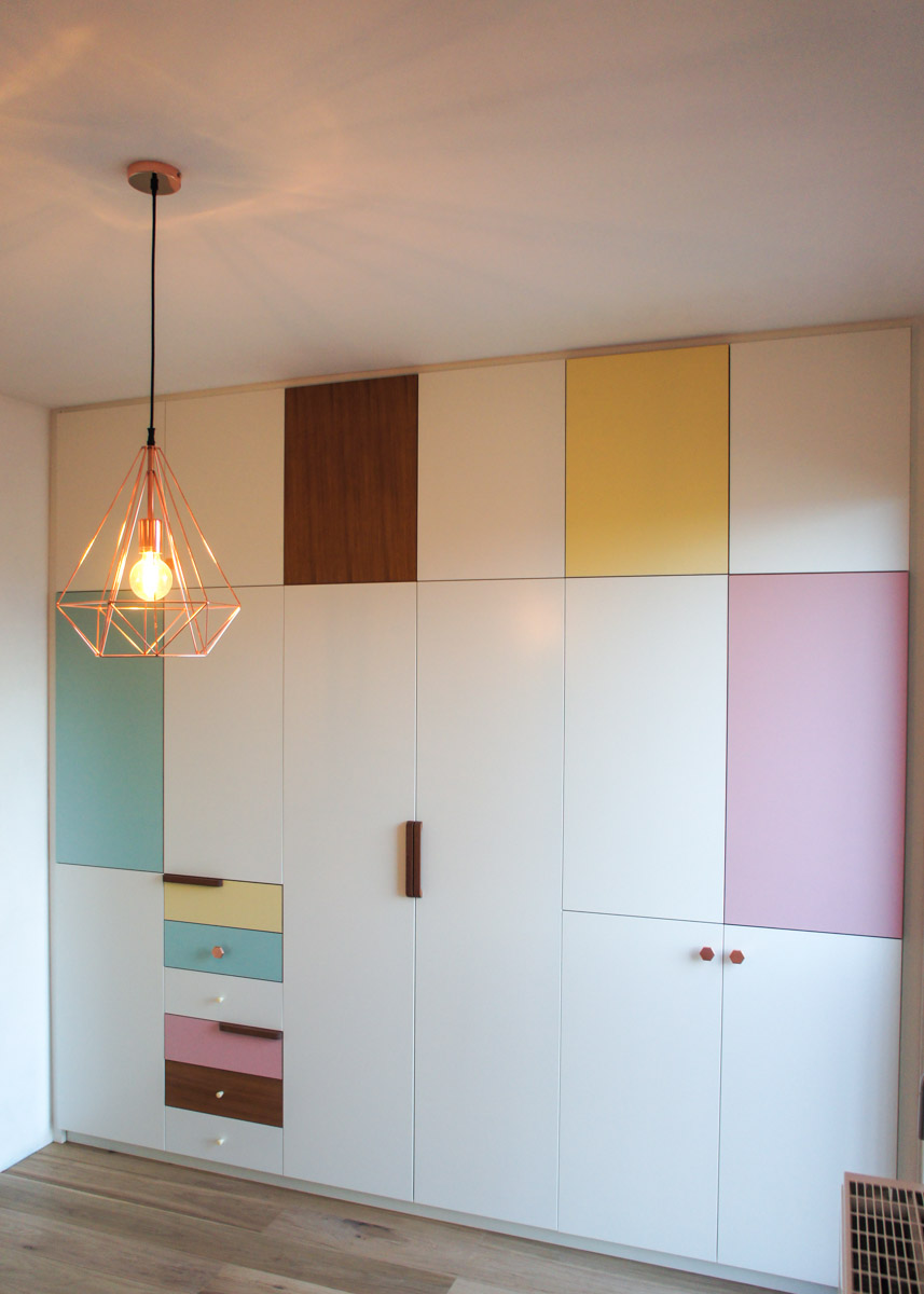 Atelier Antipode | pastel patchwork | wardrobe of white laquered doors matched with pastel laminate and oak, handmade meranti handles and copper cabinet knobs by Schoolhouse Electric