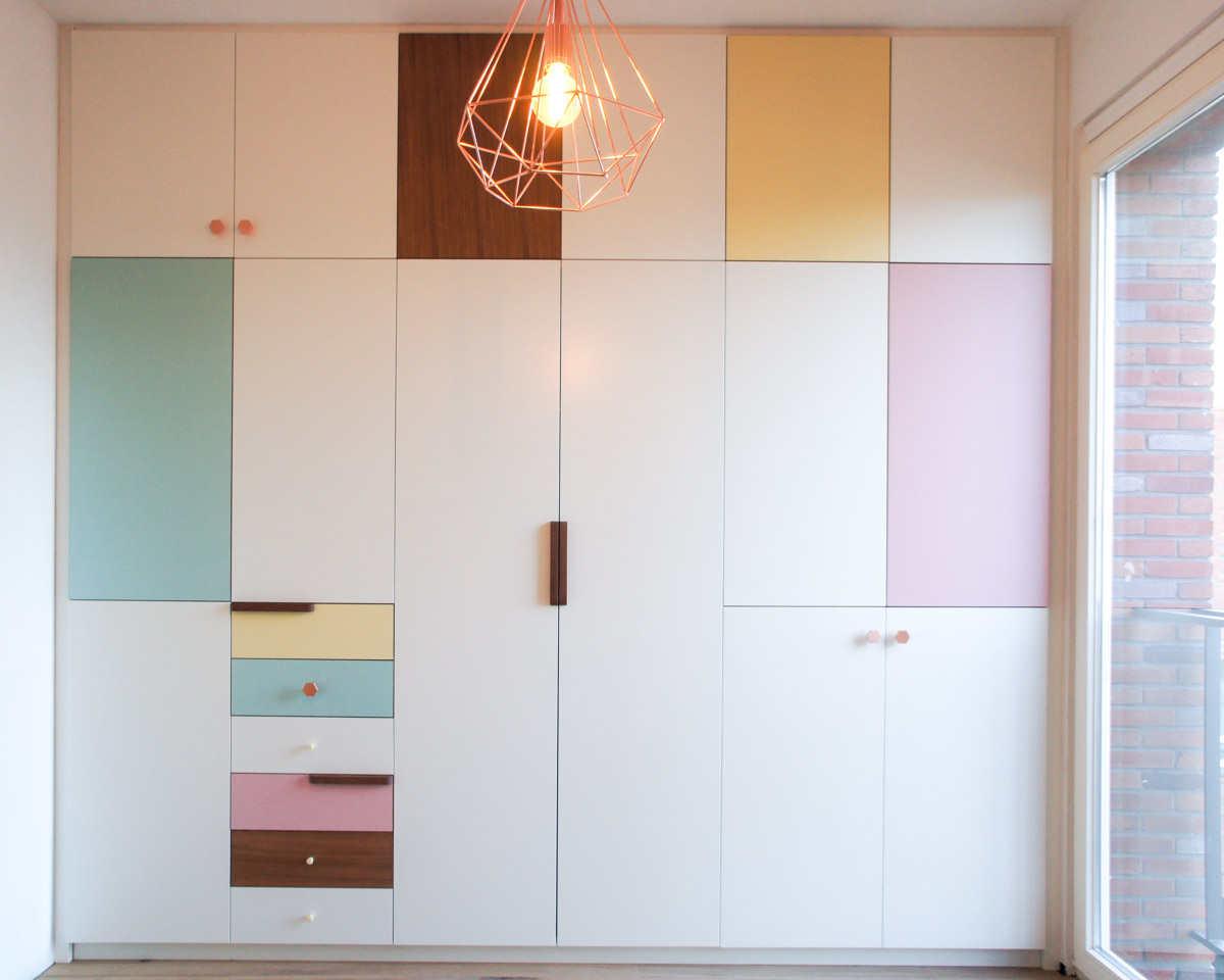 Atelier Antipode | pastel patchwork | wardrobe of white laquered doors matched with pastel laminate and oak, handmade meranti handles and copper cabinet knobs by Schoolhouse Electric
